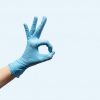 female-hand-disposable-gloves-light-blue-background_127675-2697